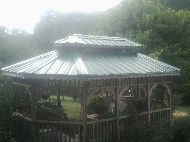 Two tier green metal roof on a garden gazebo in Hudson